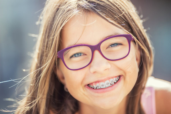 Young girl with braces smiling